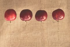 Autumn red apples hung on a linen cloth background Product Image 1