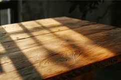 Warm sunlight casting shadows on wooden table Product Image 1