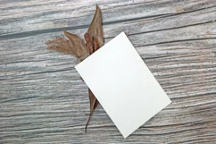 A5 paper mockup with dry leaves on wooden background Product Image 3