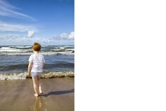 a small child walking on the shore Product Image 1