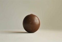 Single chocolate truffle on neutral background Product Image 1