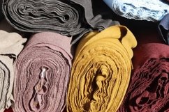 Rolled fabric samples found on a market - background Product Image 1