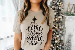 This religious holiday SVG features the phrase "O' come let us adore him" with graceful script lettering, playful flourishes, and simple star decorations surrounding the meaningful Christmas message.