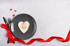 Fried egg like heart on grey plate with red decorations Product Image 1
