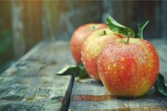 Fresh dewy apples on rustic wooden table Product Image 1