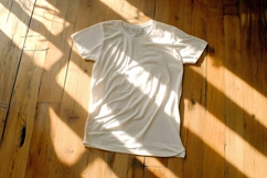 White T-shirt on a wooden background Product Image 1