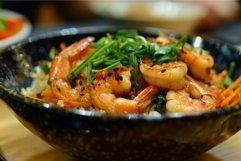 Steaming bowl of rice topped with freshly cooked prawns and Product Image 1