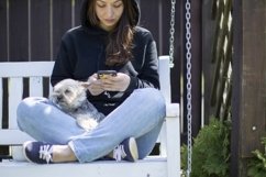 Pretty brunette in black hoodie sitting on swing Product Image 1