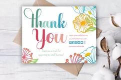 Colorful floral thank you card on desk background.