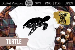 Turtle silhouette with wildflowers inside SVG design shown applied to a white shirt with plaid overshirt