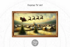 The Christmas Frame TV art shows a painting of Santa flying over a mountain town with reindeers