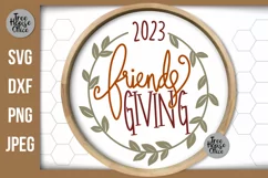 Friendsgiving 2023 with wreath SVG shown in a round wood frame  Thanksgiving with friends SVG, DXF, PNG, and JPEG file types included.