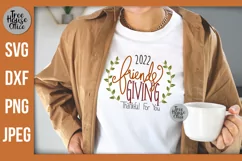 Friendsgiving 2022 with wreath Thankful For You SVG shown on a womens shirt as a project idea.  Thanksgiving with friends SVG, DXF, PNG, and JPEG file types included.