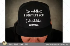 funny SVG file being displayed on a black hat worn by a man