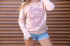 Trendy pink lettering graphic saying “Sorry For What My Face Said” in mixed script and bold fonts.