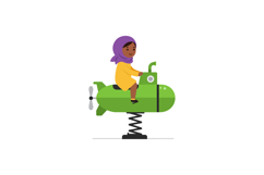 A young girl in a yellow dress riding a green submarine spri Product Image 1