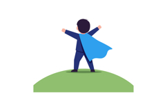 Young boy in superhero cape standing triumphantly on green h Product Image 1