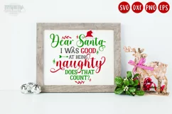 Good at Being Naughty red and green Christmas quote shown on a white sign with a wooden frame next to a reindeer decoration