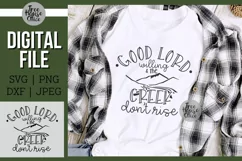 Good Lord Willing and the Creek Dont Rise Digital file design shown on a white t shirt as a finished product example.  Flannel and forest elements behind shirt.  Available in svg, png, dxf, and jpeg format.  Design has image of mountains and creek