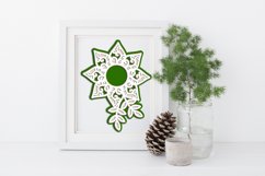 green layered mandala in frame with fir branch