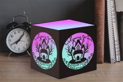 haunted house tealight box on table with clock and books
