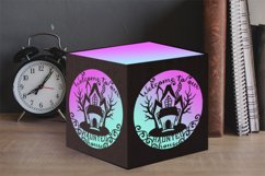 haunted house tealight box on table with clock and books