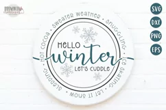 Hello winter farmhouse script text shown on a white round sign