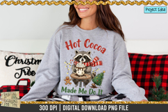Cute raccoon holding a hot cocoa mug with Christmas decorations, ideal for holiday shirts, mugs, and sublimation crafts.
