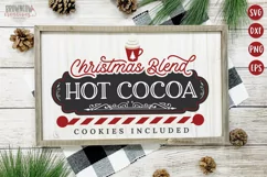 Hot cocoa bar sign with a chalkboard frame and a red and white candy cane striped horizontal pole shown on a white framed sign