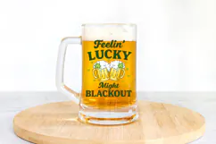 High resolution St. Paddy’s Day drinking shirt graphic featuring beer mugs, shamrocks, and lucky phrase in rich green tones.