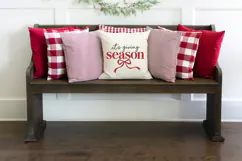 This Christmas typography SVG features oversized red "season" lettering beneath smaller handwritten-style words, finished with a flowing red bow and gently curved ribbon tails.