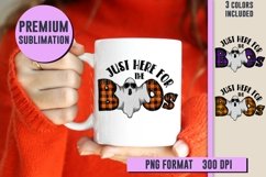 halloween design on white coffee mug held by girl in orange sweater