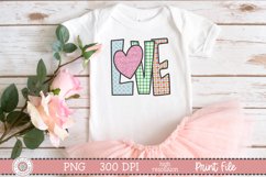 Hand lettered love sublimation design on a white child’s shirt