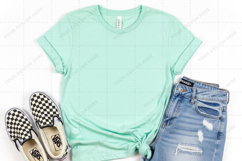 Casual summer outfit with mint green t-shirt and distressed Product Image 1