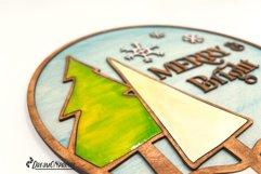 Round Christmas sign made for laser cutting machines. Includes the saying "Merry and Bright"and 2 Christmas trees.