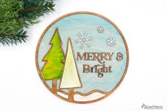 Round Christmas sign made for laser cutting machines. Includes the saying "Merry and Bright"and 2 Christmas trees.