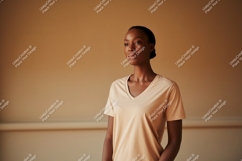 Woman wearing peach t shirt looking away image Product Image 1