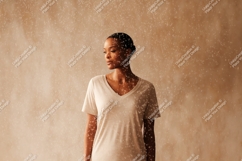 Woman wearing simple v-neck t-shirt light neutral Product Image 1