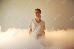 Woman wearing white t shirt and grey pants in smoke Product Image 1