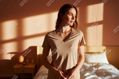 Woman wearing beige t shirt in warm light image Product Image 1