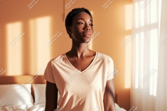 Woman wearing peach t shirt in sunlit room t-shirt Product Image 1