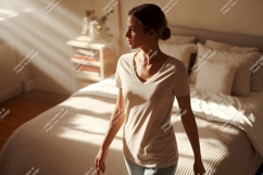 Woman wearing t-shirt in bedroom light shadows Product Image 1