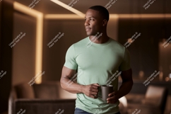 Man wearing green t shirt holding coffee mug t-shirt Product Image 1