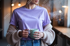 Woman holding mug wearing lavender t shirt and cardigan Product Image 1