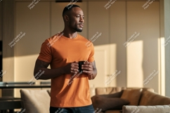 Man orange t-shirt holding coffee mug Product Image 1