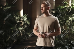 Man wearing tan t shirt holding mug image Product Image 1