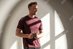 Man wearing maroon t shirt holding mug image Product Image 1