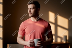 Man wearing coral t shirt holding mug image Product Image 1