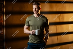 Muscular man holding coffee mug image Product Image 1