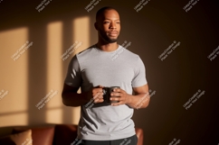 Man holding coffee mug in sunlit room grey Product Image 1